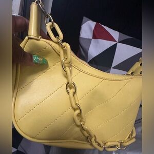 Cute yellow purse with chain handle and cross body strap! Very rarely used.